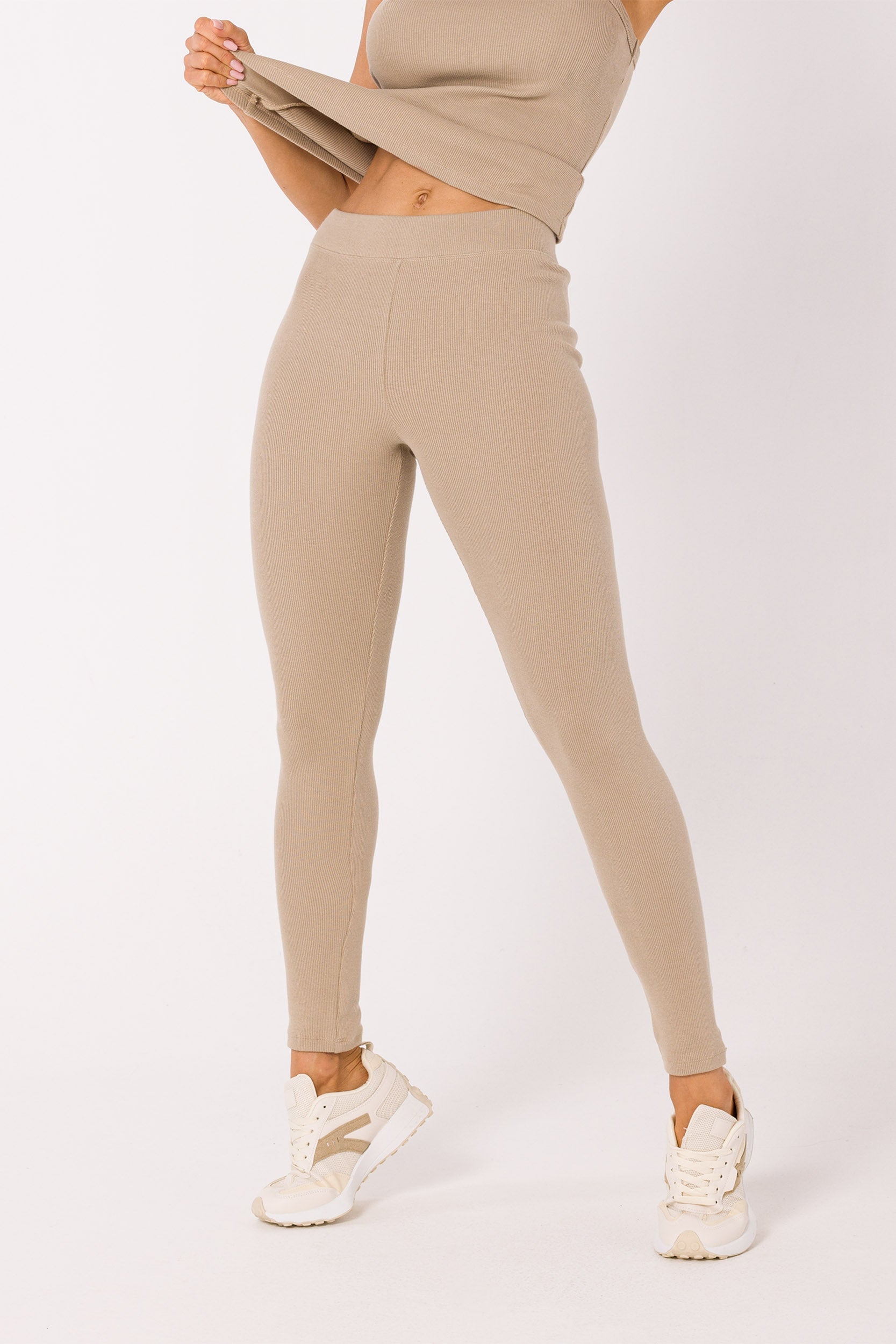 Upgrade your wardrobe with our Beige Ribbed Knit Leggings. Crafted from high-quality ribbed knit fabric, these leggings can be worn as a set with our matching tank top or mixed and matched for various chic outfits. Their neutral beige hue makes them perfect for loungewear, working from home, sports, and running errands. Experience the comfort and style of this essential piece that adapts to your everyday fashion needs.