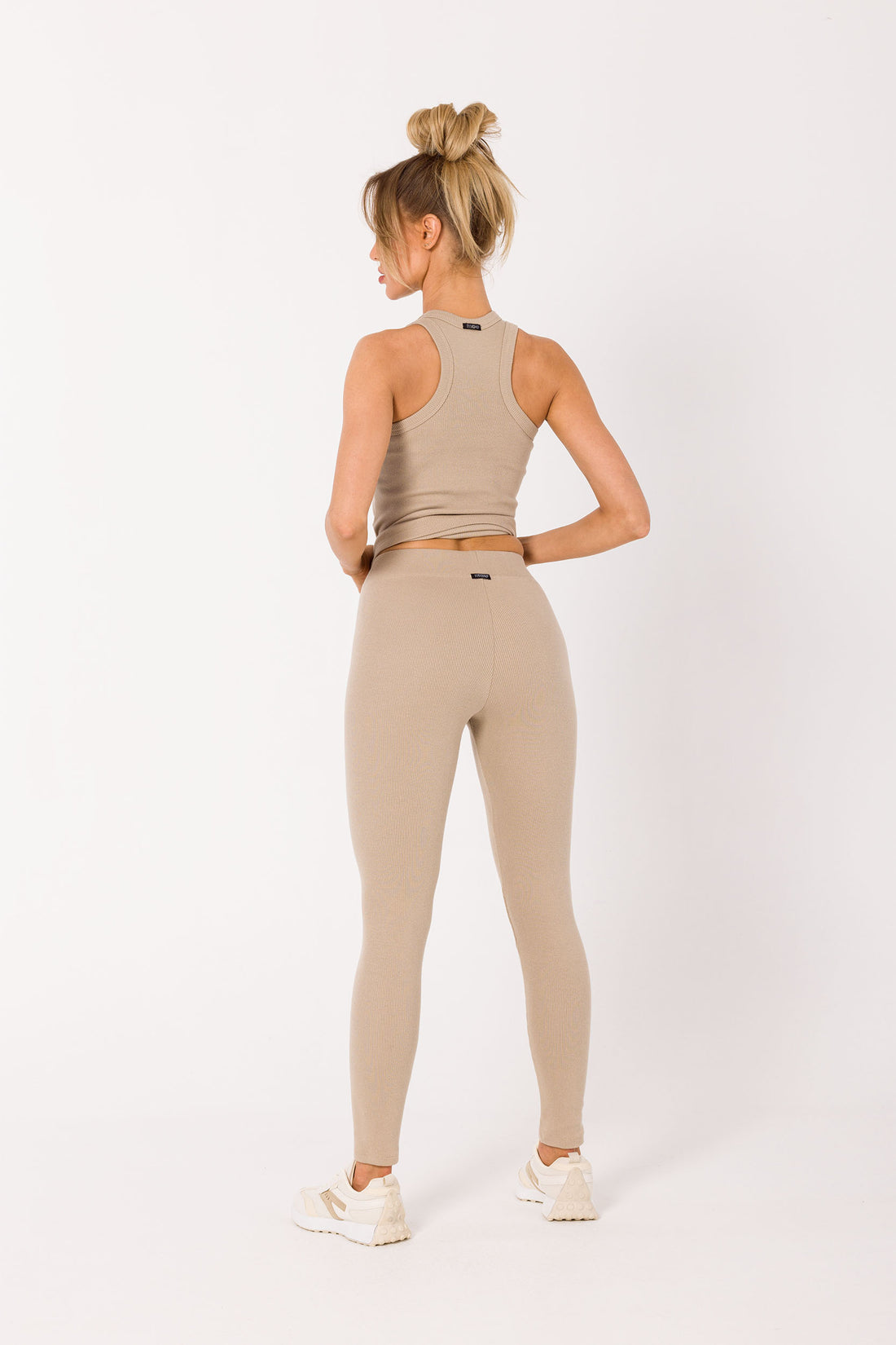 Upgrade your wardrobe with our Beige Ribbed Knit Leggings. Crafted from high-quality ribbed knit fabric, these leggings can be worn as a set with our matching tank top or mixed and matched for various chic outfits. Their neutral beige hue makes them perfect for loungewear, working from home, sports, and running errands. Experience the comfort and style of this essential piece that adapts to your everyday fashion needs.