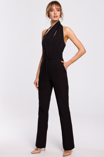 Our women's jumpsuit with pockets is the pinnacle of fashion and utility. This exquisite jumpsuit, which has a captivating open-back design and a subtly asymmetric neck halter neckline with a stylish cut-out detail, expertly combines simplicity and elegance. The front strap also features an innovative design and can be adjusted in length using two discrete hidden buttons for more a tailored fit. 