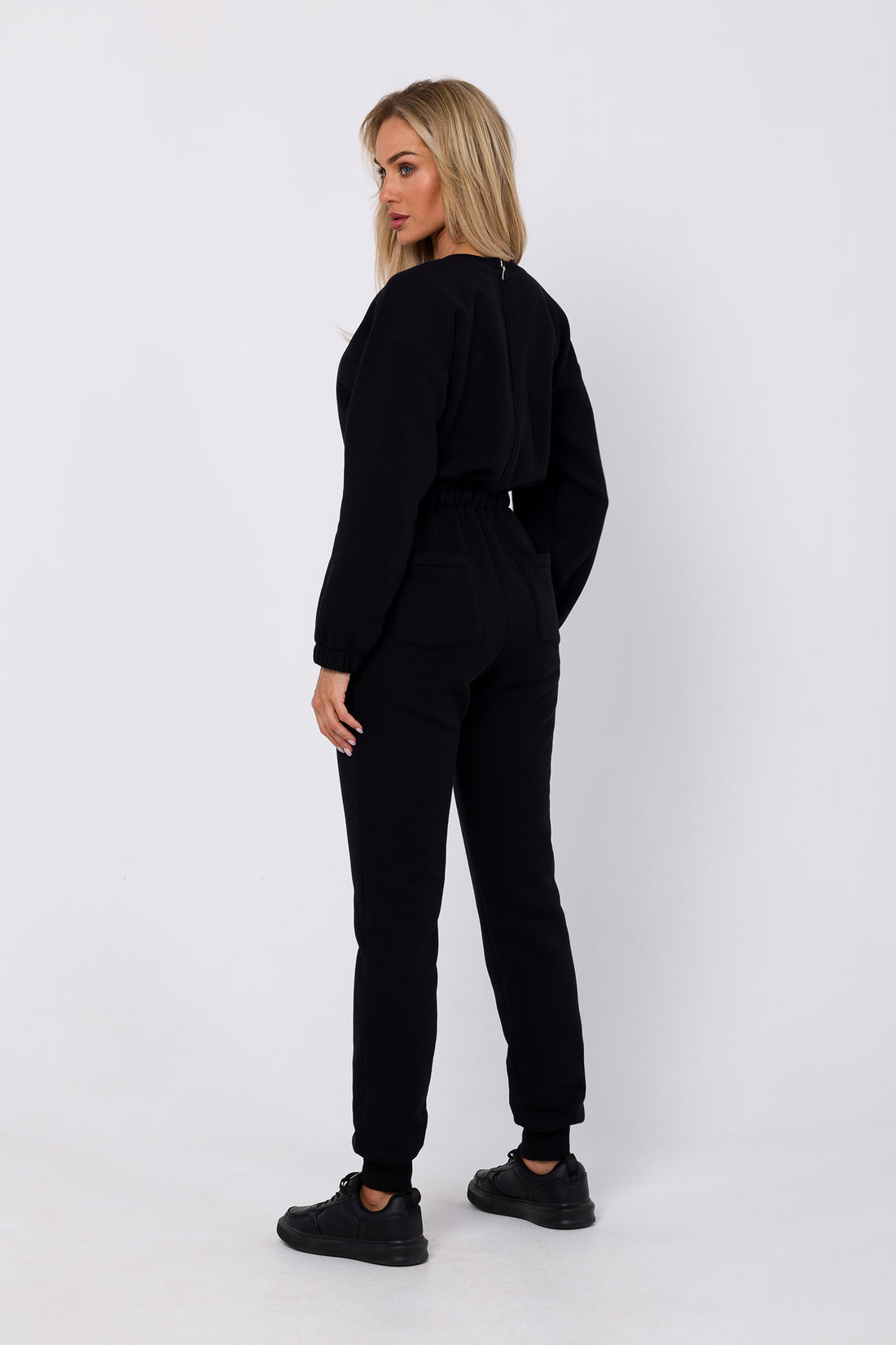 One-Piece Sweatshirt Jumpsuit | Strictly In | Embrace casual chic with our knit one-piece jumpsuit. Long sleeves, elasticated waist, and practical pockets make it your go-to for easy, stylish comfort.
