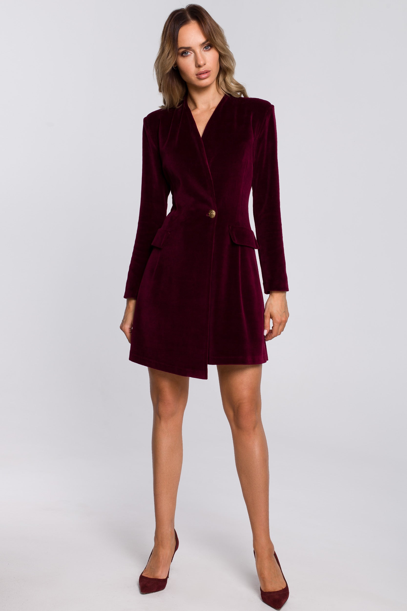 Elevate your style with our velvet mini dress. Featuring a V-neckline, long sleeves, and a single-button closure, this blazer dress is perfect for special occasions. Made from high-quality knit velvet fabric, it offers both comfort and opulence.